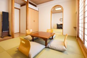 a dining room with a table and chairs at Ryokan Asakusa Shigetsu in Tokyo