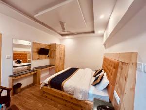 a bedroom with a wooden bed and a mirror at Manali Castle - Wonder Hill in Manāli