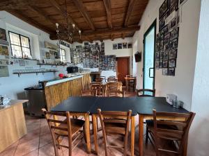 a dining room with a black table and chairs at Hotel Duca di Tromello in Tromello