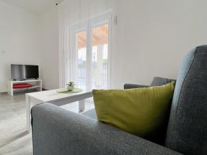 a living room with a couch and a table at Evergreen & Pinky Apartments close to the Beach in Rab