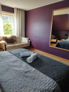 a bedroom with a large bed and a mirror at Fjord House in Grimo