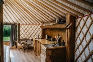 a kitchen in a yurt with a sink and a counter at Jurta a Duna-parton in Zebegény