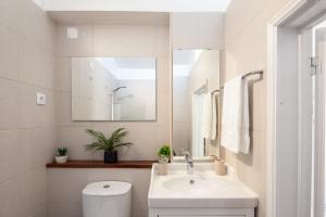 a white bathroom with a sink and a toilet at Silvercoast Apartments - swimming pool & jacuzzi in Atouguia da Baleia +38 photos
