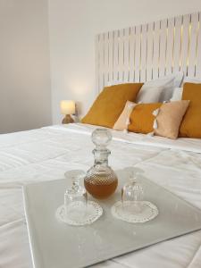 a white bed with two glass containers on a tray at Galaxa Mansion in Galaxidi