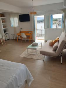 a living room with a bed and a couch and a table at Galaxa Mansion in Galaxidi