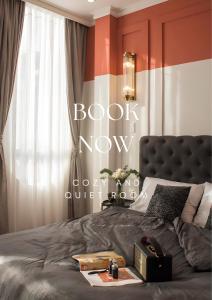 a bedroom with a bed with a book now sign on it at RL Boutique Dalat in Da Lat