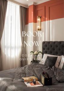 a bedroom with a bed with a book now sign on it at RL Boutique Dalat in Da Lat
