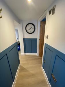 a hallway with a clock on the wall at Seasteps Padstow in Padstow