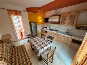 a kitchen with a table and chairs in a room at Appartamenti Levante - Agenzia Cocal in Caorle