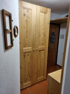 a wooden cabinet in a room with a door at Bellavista in Madesimo