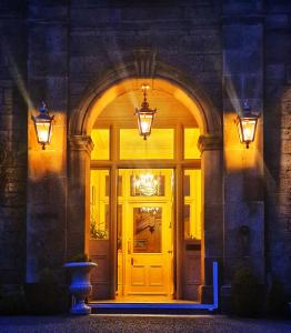 an entrance to a building with a yellow door at The Pines Guest House in Elgin