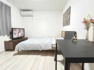 Postel nebo postele na pokoji v ubytování ティエラ北池袋