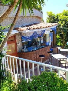 an outdoor bar with stools and tables in a building at Villa Elvira in Pellezzano +23 photos