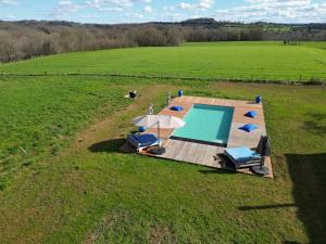 an overhead view of a wooden deck with a swimming pool at La Demeure en Périgord in Anlhiac