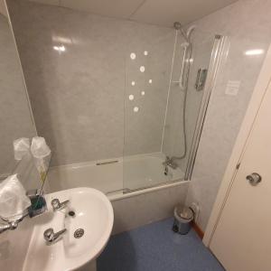 a bathroom with a shower and a sink and a toilet at The Brae Hotel in Brae