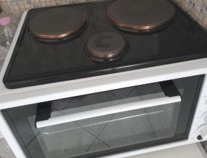 a stove top oven with three burners on it at Vanessa's studio in Agia Triada