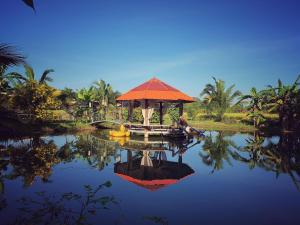 a gazebo sitting on top of a body of water at Baan Hug Na in Ban Khao Chakan