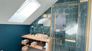 a bathroom with a sink and a shower at La Demeure en Périgord in Anlhiac