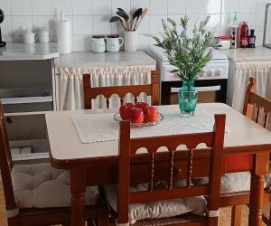 a table with apples and a vase of flowers on it at Cal Robert in Penellas +22 photos
