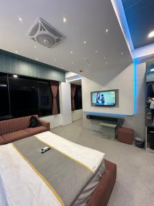 a living room with a large bed and a flat screen tv at Hotel victoria prime in Surat
