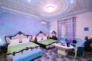 a bedroom with two beds and a table and chairs at Caravan Castle Boutique Hotel in Bukhara +60 photos