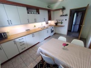 a kitchen with a table with a vase of flowers on it at Apartament Kapi in Kalwaria Zebrzydowska