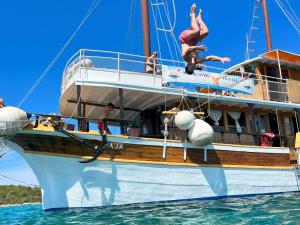 a group of people jumping off of a boat in the water at Rhythm Floating Accom - Split in Split
