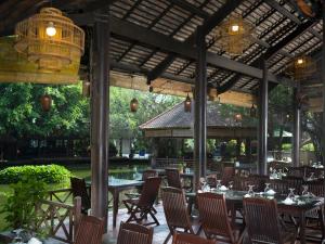 a restaurant with tables and chairs and a pavilion at Phuong Nam Resort in Thuan An