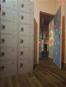 a room with lockers and a room with a refrigerator at Backpackers Hostel in Dubai