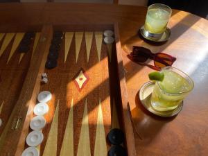 a game of checkers with a drink on a table at Iliokambida house in Corfu