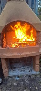een bakstenen oven met een vuur erin bij Relax2 in Il Romito