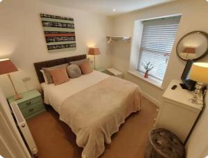 a bedroom with a large bed and a window at No 1A Penlee in Penzance