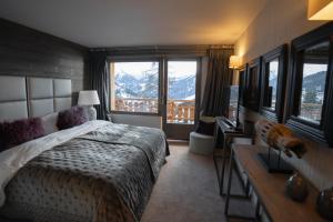 a bedroom with a bed and a view of a mountain at No 14 Verbier in Verbier