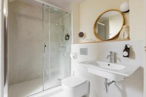 a bathroom with a shower and a toilet and a sink at Frenchdoor Orléans Cloître in Orléans