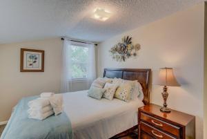 a bedroom with a bed with pillows and a lamp at 3BR DOWNTOWN - NEW Hot Tub - Olympic Training Center in Colorado Springs