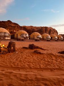 a group of domes in the middle of a desert at Revan Rum Luxury Camp in Wadi Rum