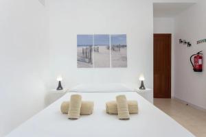a white room with two pillows on a table at BLife Benya private apartment in Faro