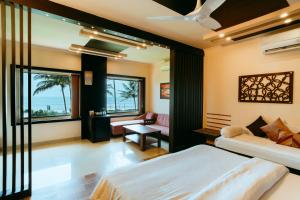 a bedroom with two beds and a view of the ocean at Asokam Beach Resort in Kannur