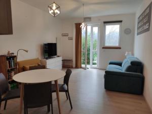 a living room with a table and a couch at Casa Vacanza Mattirolo - Castagneto Po in Castagneto Po