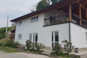 a white house with a balcony on top of it at Casa Vacanza Mattirolo - Castagneto Po in Castagneto Po