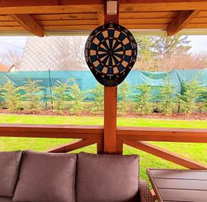 a dart board on a pole in a porch at Dénár Apartmanház in Veresegyház