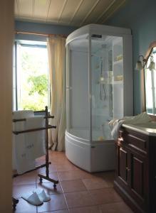 a bathroom with a shower and a sink at Sto Roloi Island Houses in Poros
