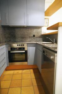 a kitchen with white cabinets and a stove at Anna in L'Escala