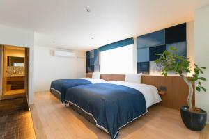 Postel nebo postele na pokoji v ubytování Nagi Kurashiki Hotel&Lounge