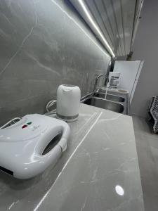 a toaster sitting on a counter next to a sink at Meraki house of kalymnos Apartments in Kalymnos