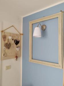 a door with a mirror and a lamp and a window at Casa Vacanze Susanna in Monfalcone