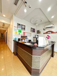 a restaurant with a counter in a room at Rainbow Hotel in Alor Setar