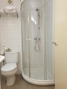 a bathroom with a shower and a toilet at Hotel Ancora in Palamós