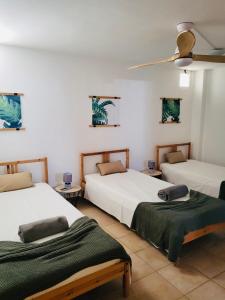 a bedroom with two beds and a ceiling at Sand, Water & Sun House in Vila Nova De Cacela