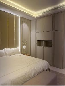 a bedroom with a white bed and a large closet at fin apartment C6 in Riyadh